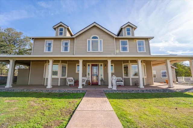 a view of a hallway with wooden floor and a chandelier