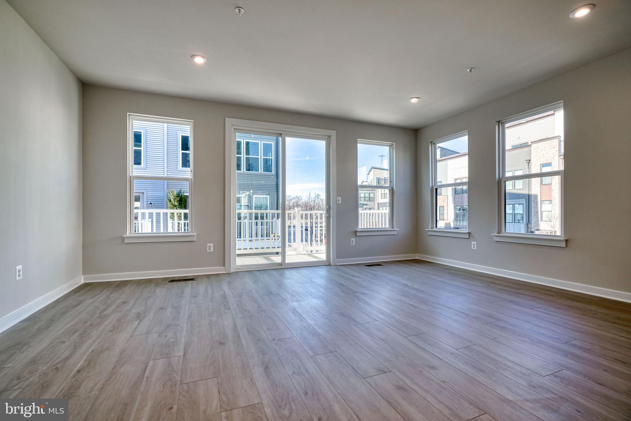 5612 Alpha Ridge Avenue Hyattsville, MD 20782 - Photo 19 of 70 a view of an empty room with wooden floor and a window