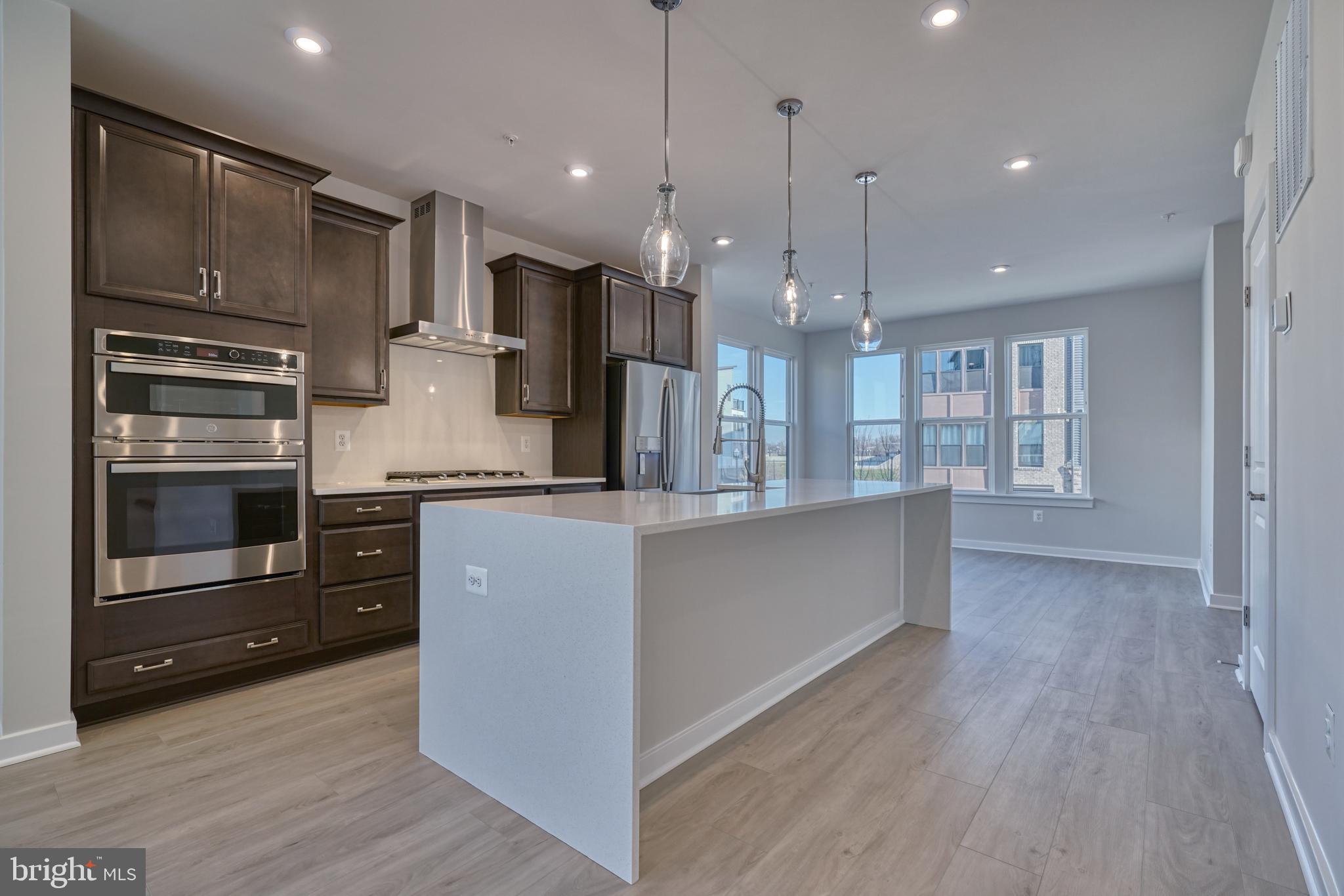 5612 Alpha Ridge Avenue Hyattsville, MD 20782 - Photo 22 of 70 a kitchen with stainless steel appliances kitchen island granite countertop a refrigerator and a stove top oven