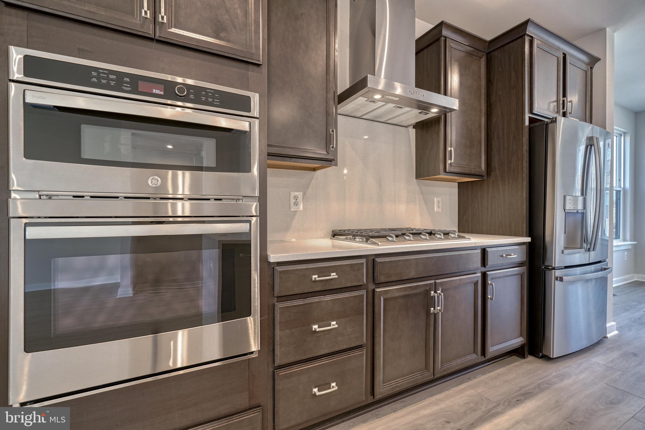 5612 Alpha Ridge Avenue Hyattsville, MD 20782 - Photo 25 of 70 a kitchen with stainless steel appliances granite countertop a stove and a refrigerator