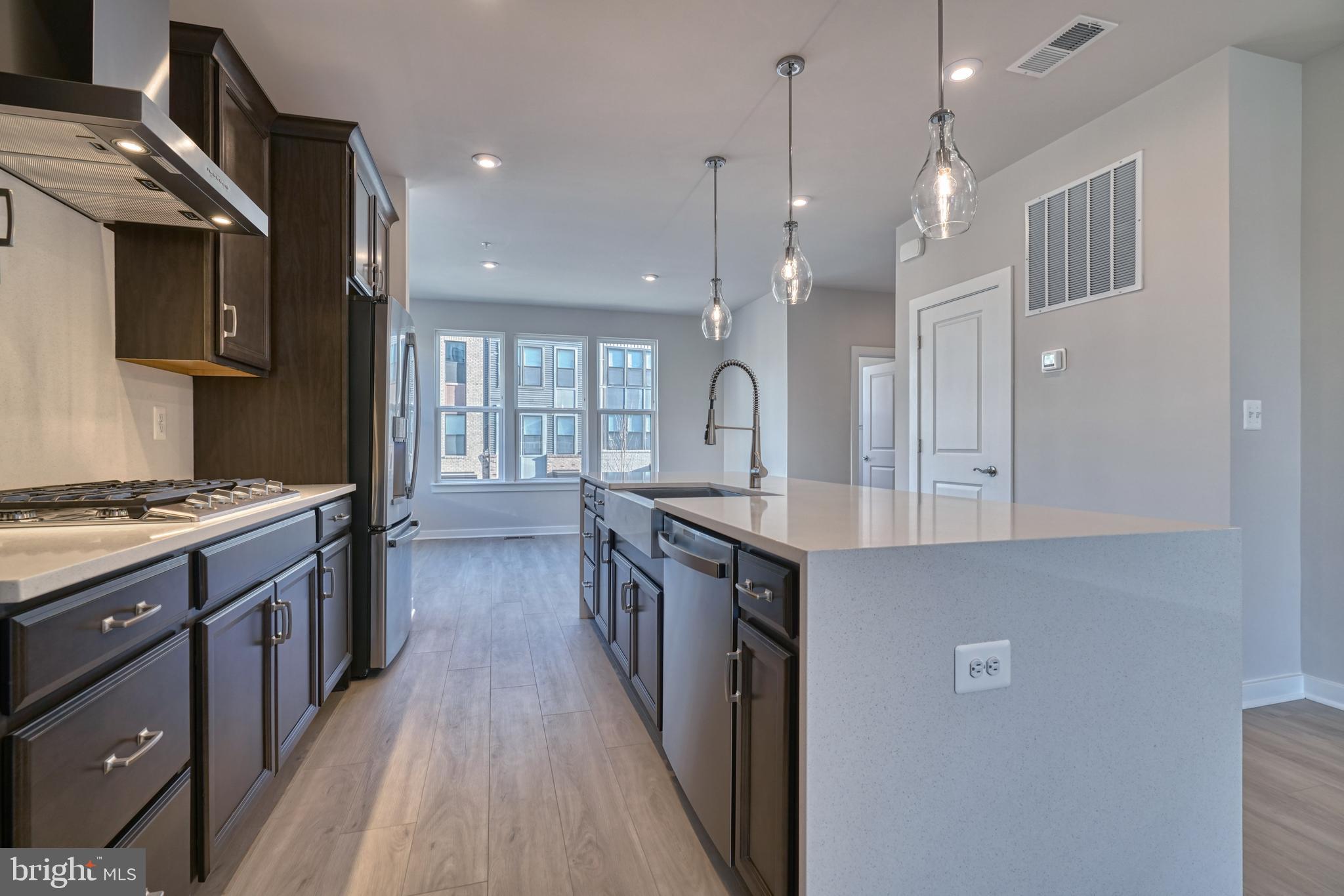 5612 Alpha Ridge Avenue Hyattsville, MD 20782 - Photo 26 of 70 a large kitchen with stainless steel appliances a large counter top a stove and a refrigerator