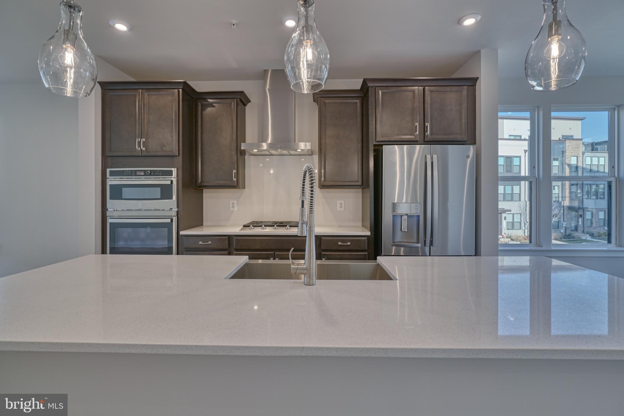 5612 Alpha Ridge Avenue Hyattsville, MD 20782 - Photo 29 of 70 a kitchen with kitchen island a counter top space stainless steel appliances and cabinets