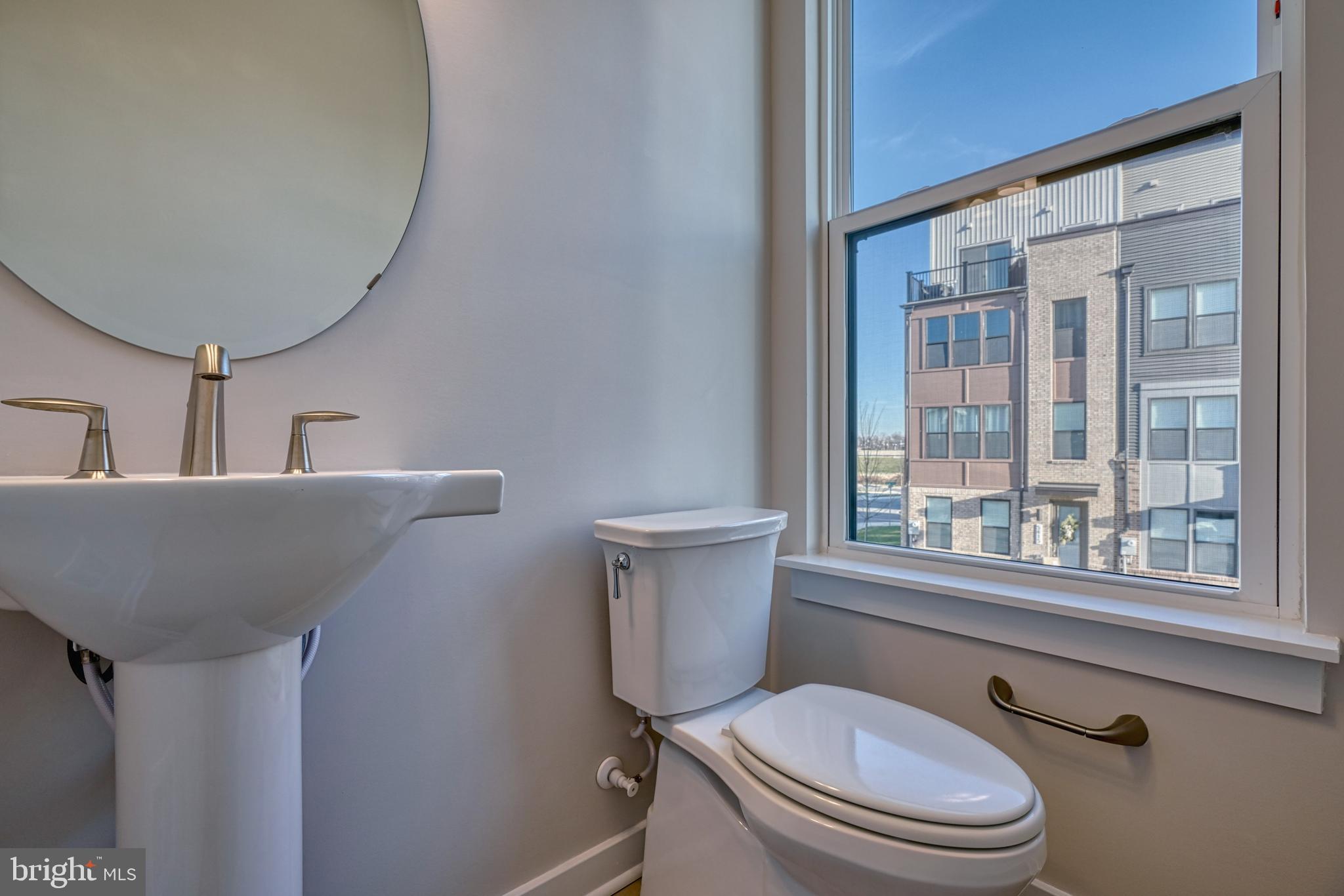 5612 Alpha Ridge Avenue Hyattsville, MD 20782 - Photo 31 of 70 a bathroom with a toilet a sink and a window