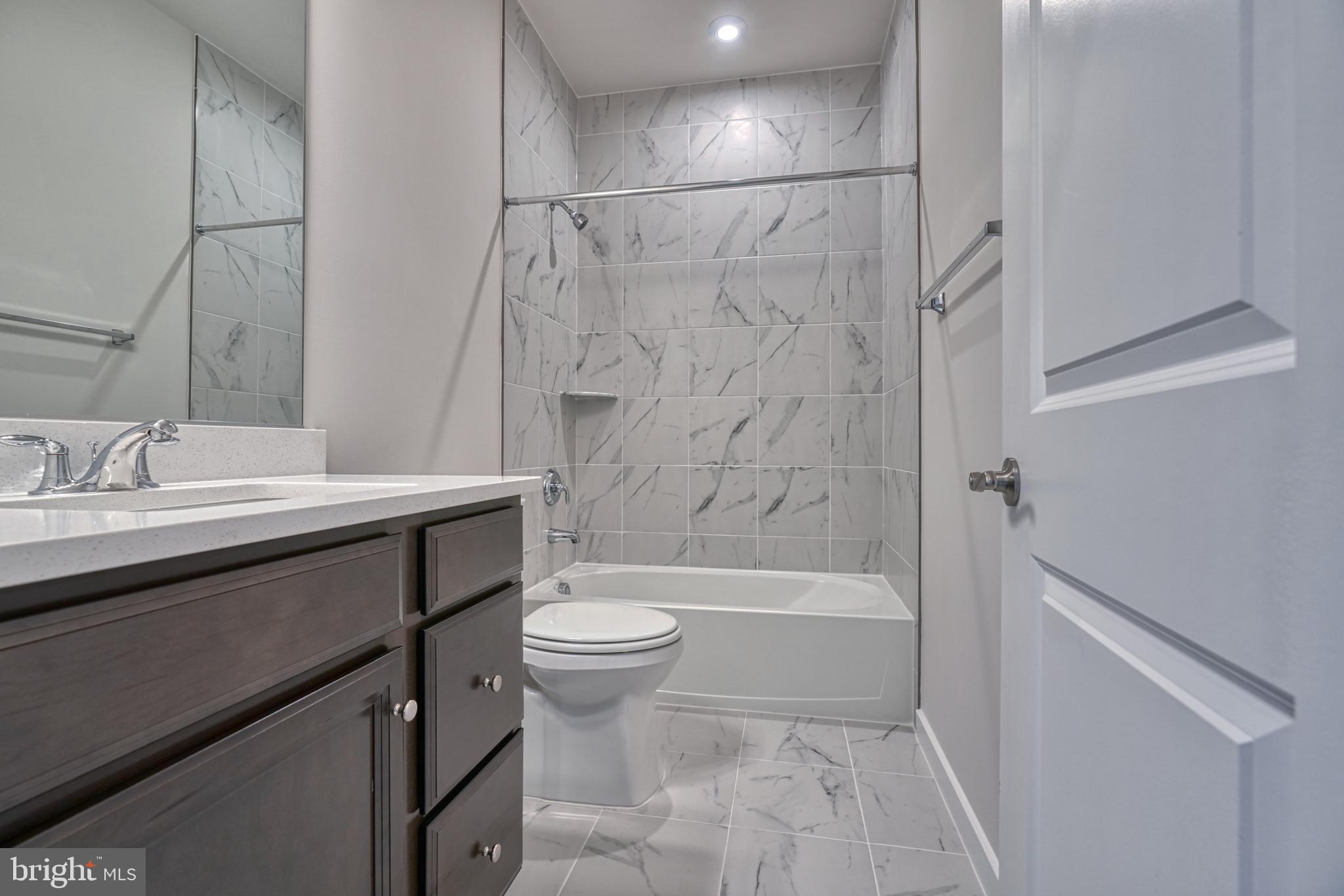 5612 Alpha Ridge Avenue Hyattsville, MD 20782 - Photo 38 of 70 a bathroom with a sink a toilet and shower