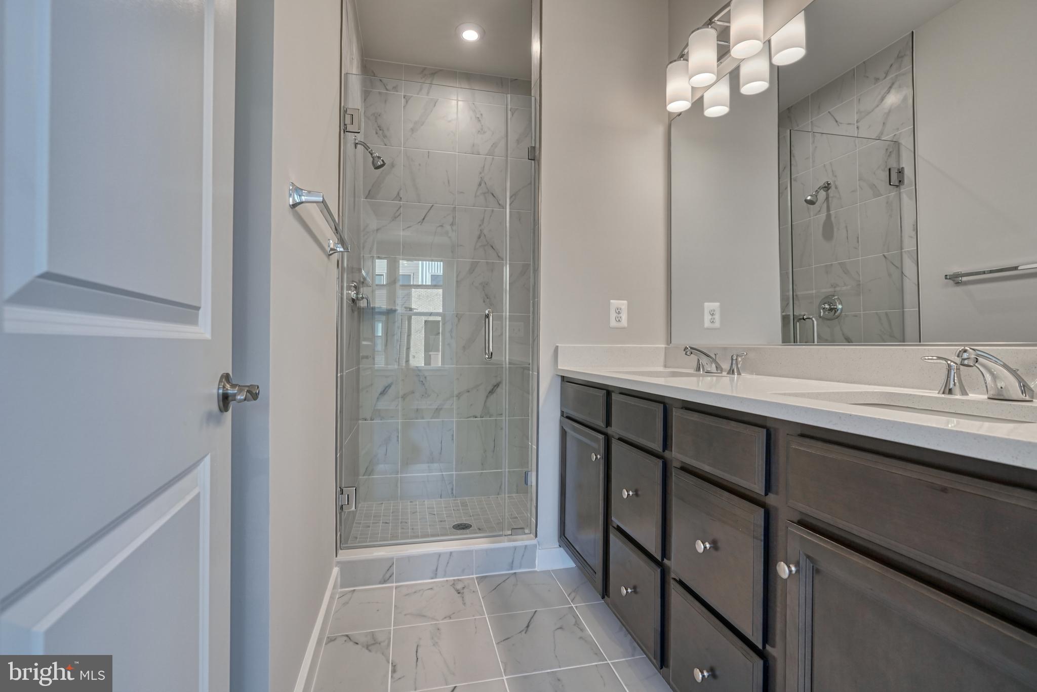 5612 Alpha Ridge Avenue Hyattsville, MD 20782 - Photo 44 of 70 a bathroom with a shower sink and mirror