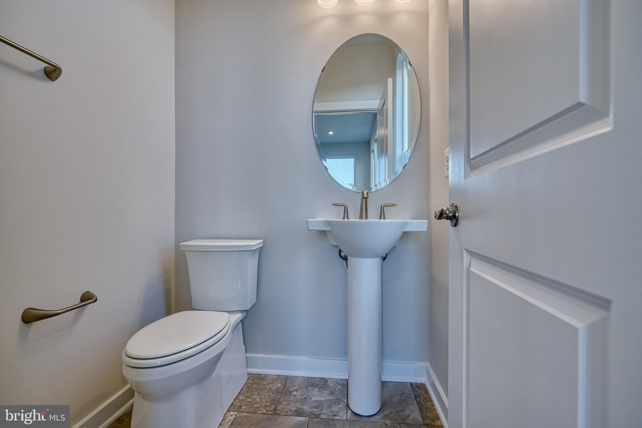5612 Alpha Ridge Avenue Hyattsville, MD 20782 - Photo 50 of 70 a bathroom with a toilet sink and mirror