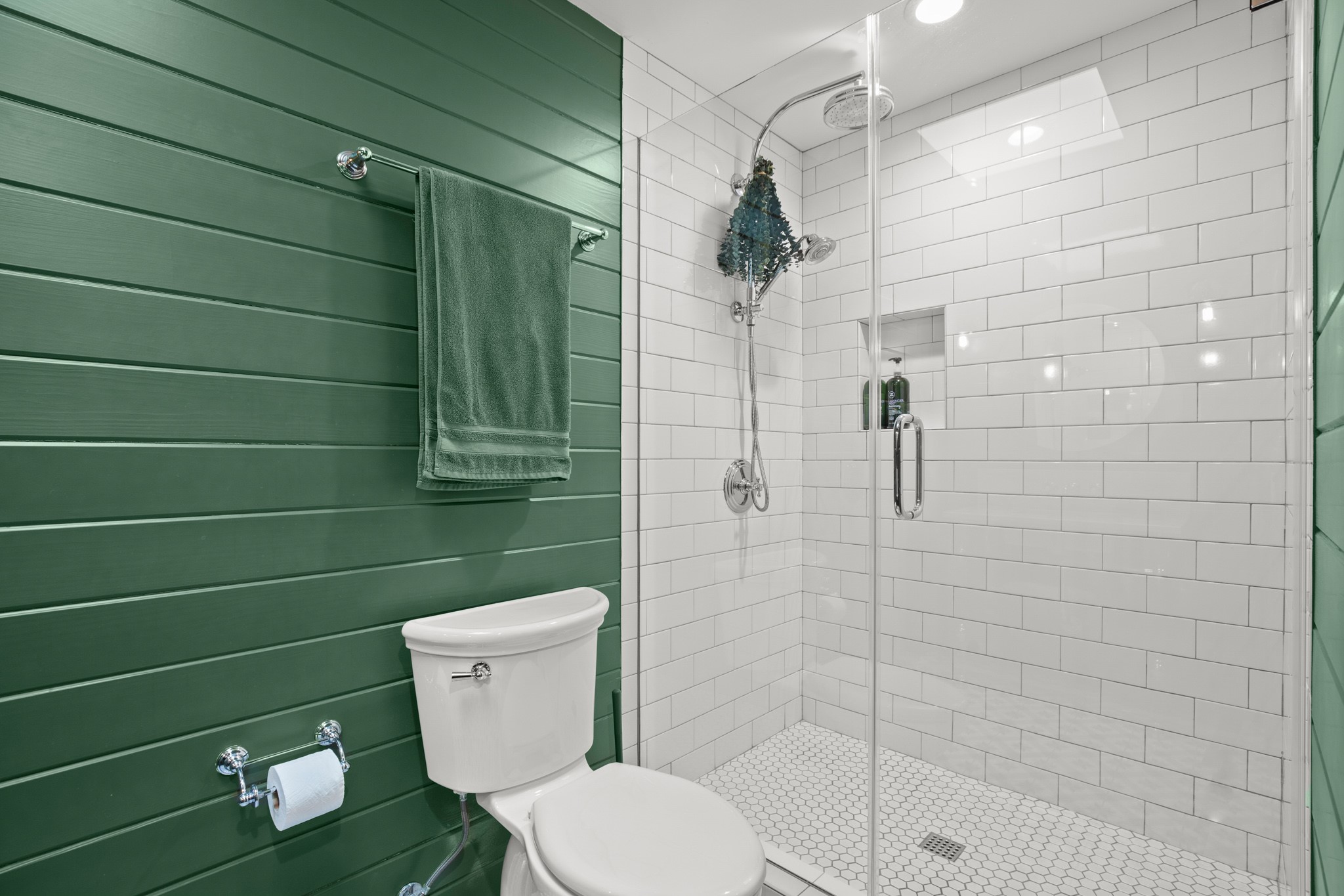 1601 Whitney Way Austin, TX 78741 - Photo 13 of 30 A sleek, contemporary bathroom features a glass-enclosed shower and shiplap paneling.