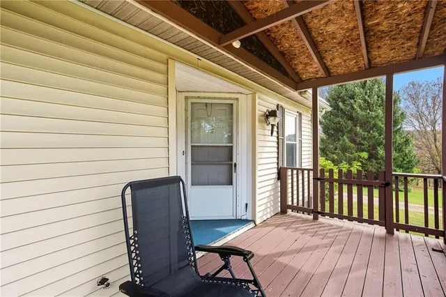 a balcony with table and chairs