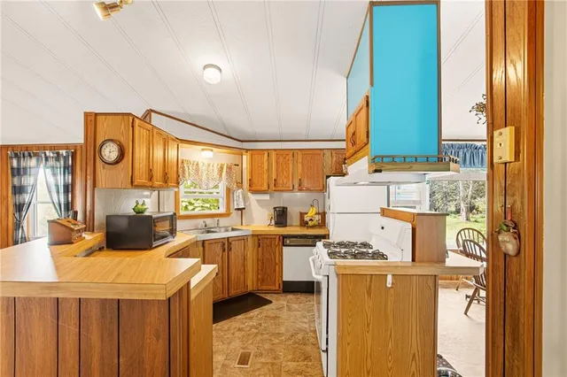 a kitchen with a stove a refrigerator and a sink