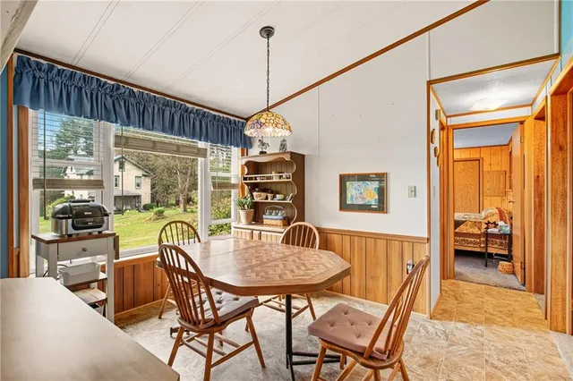 a dining room with furniture and window
