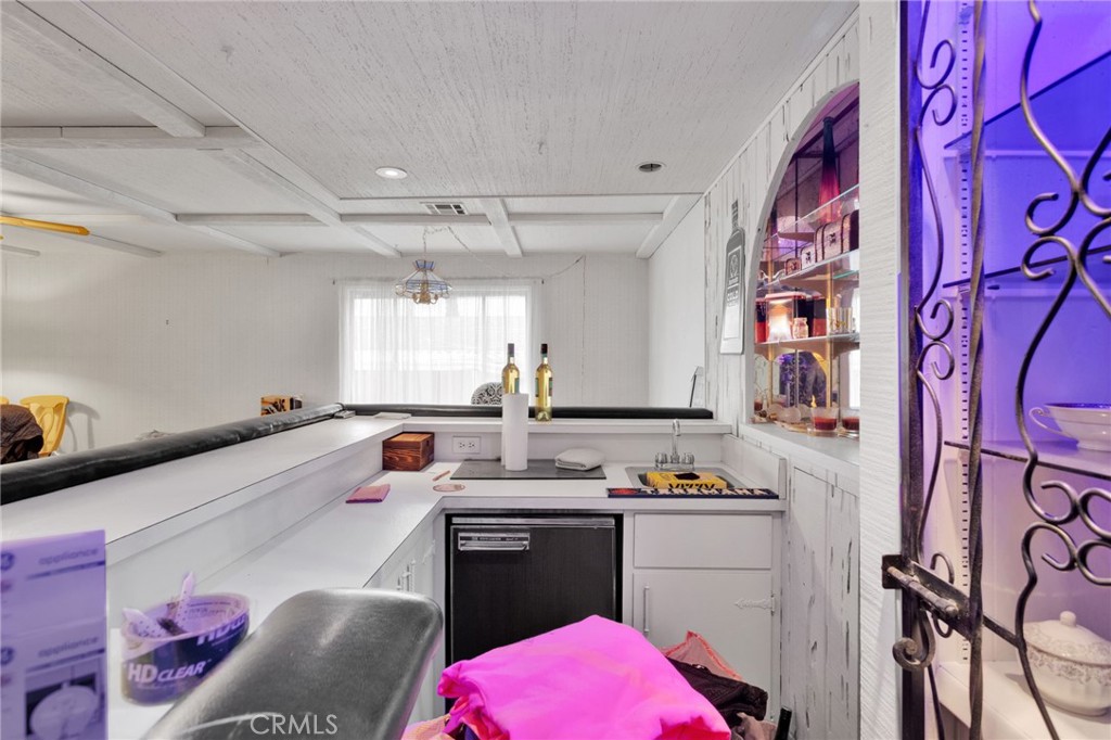 2494 Main Street Barstow, CA 92311 - Photo 12 of 36 a white kitchen with a sink stove and refrigerator