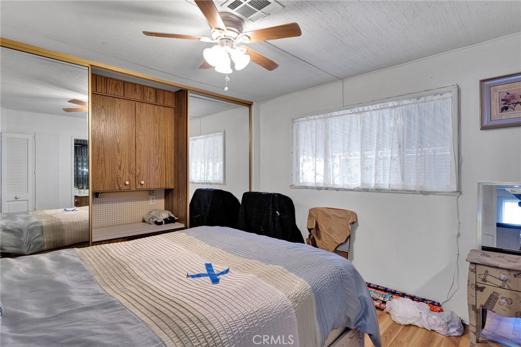 2494 Main Street Barstow, CA 92311 - Photo 19 of 36 a bedroom with a bed and a chandelier