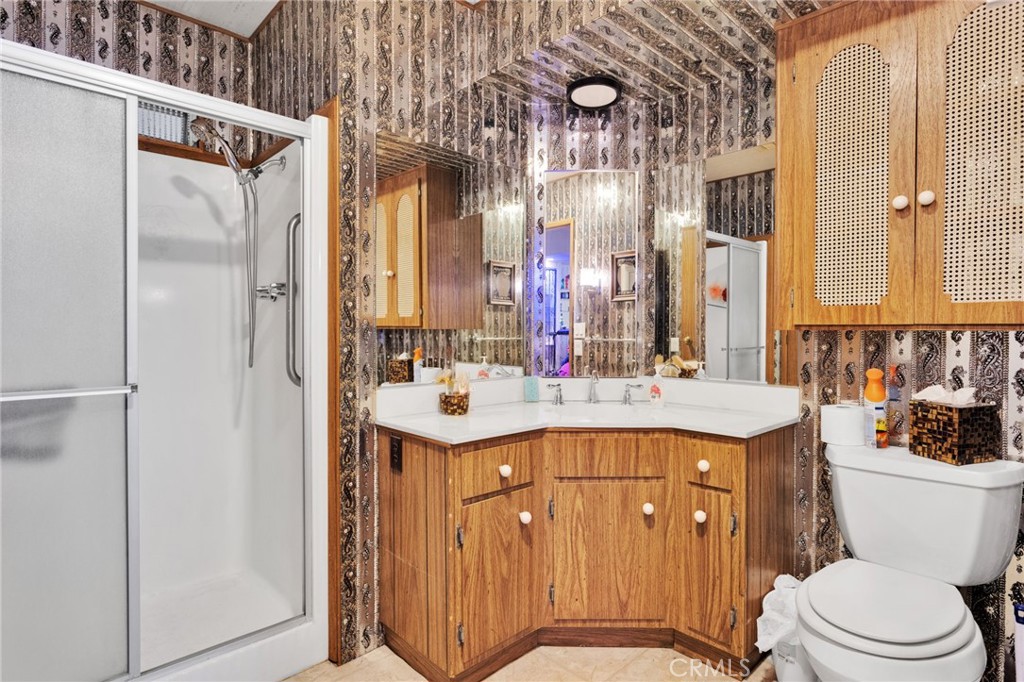 2494 Main Street Barstow, CA 92311 - Photo 21 of 36 a bathroom with a sink a toilet a mirror and shower