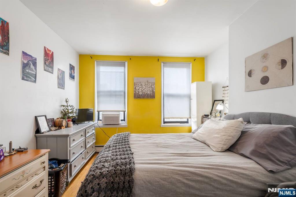 413 Adams Street Hoboken, NJ 07030 - Photo 14 of 40 a bedroom with a bed and a window
