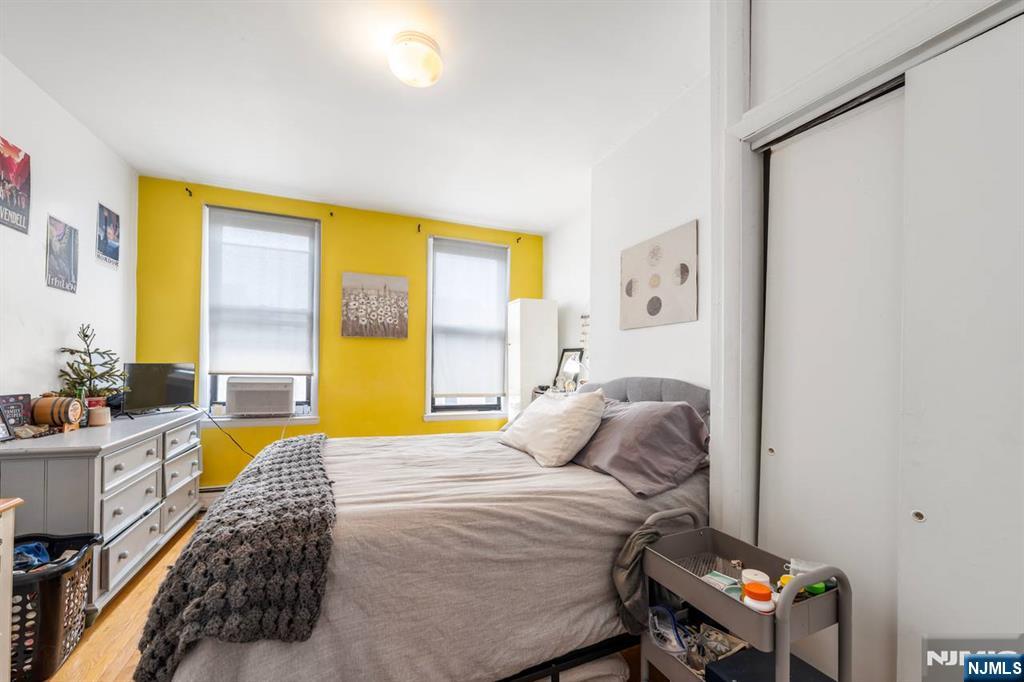 413 Adams Street Hoboken, NJ 07030 - Photo 15 of 40 a bedroom with a bed and a window