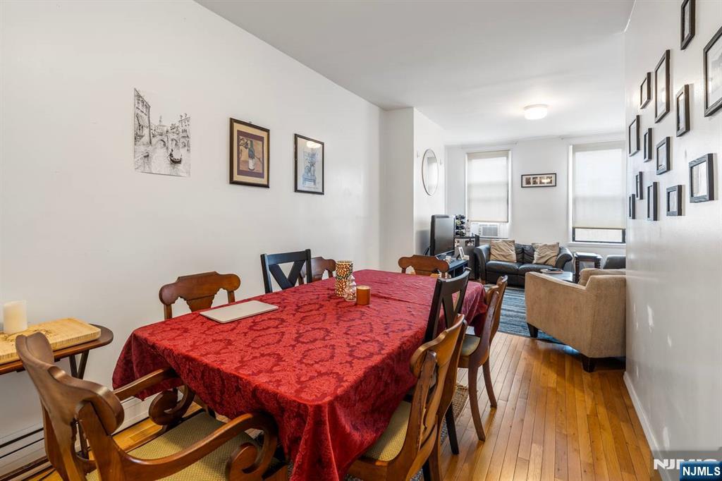413 Adams Street Hoboken, NJ 07030 - Photo 17 of 40 a view of a dining room with furniture and wooden floor