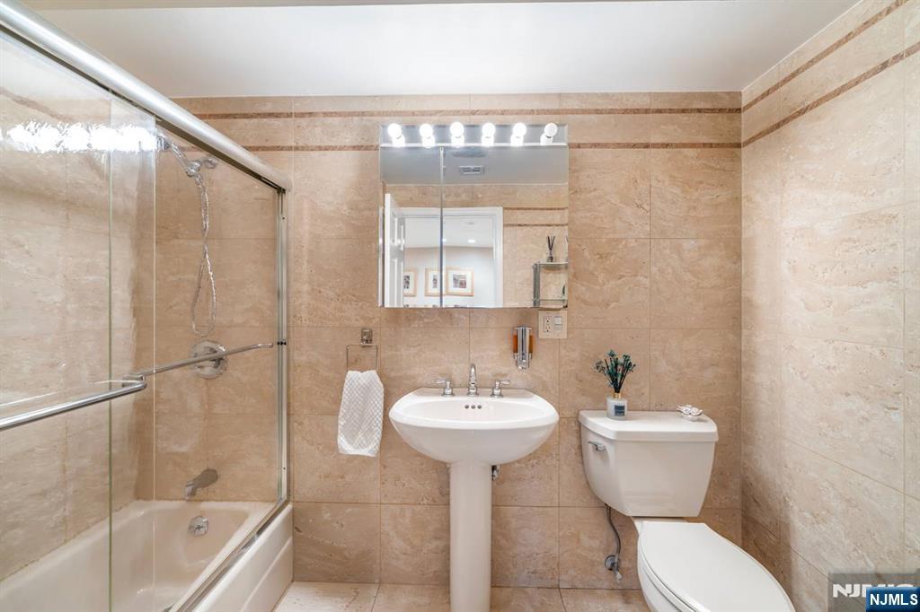 413 Adams Street Hoboken, NJ 07030 - Photo 28 of 40 a bathroom with a sink toilet and shower