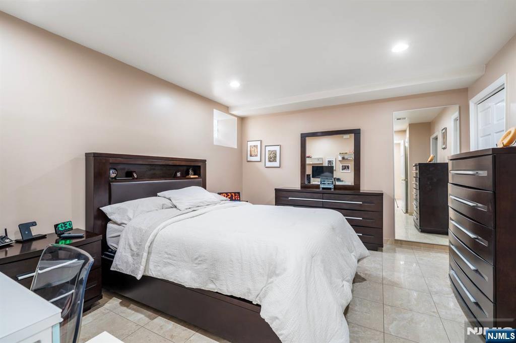 413 Adams Street Hoboken, NJ 07030 - Photo 30 of 40 a bedroom with a bed and a television