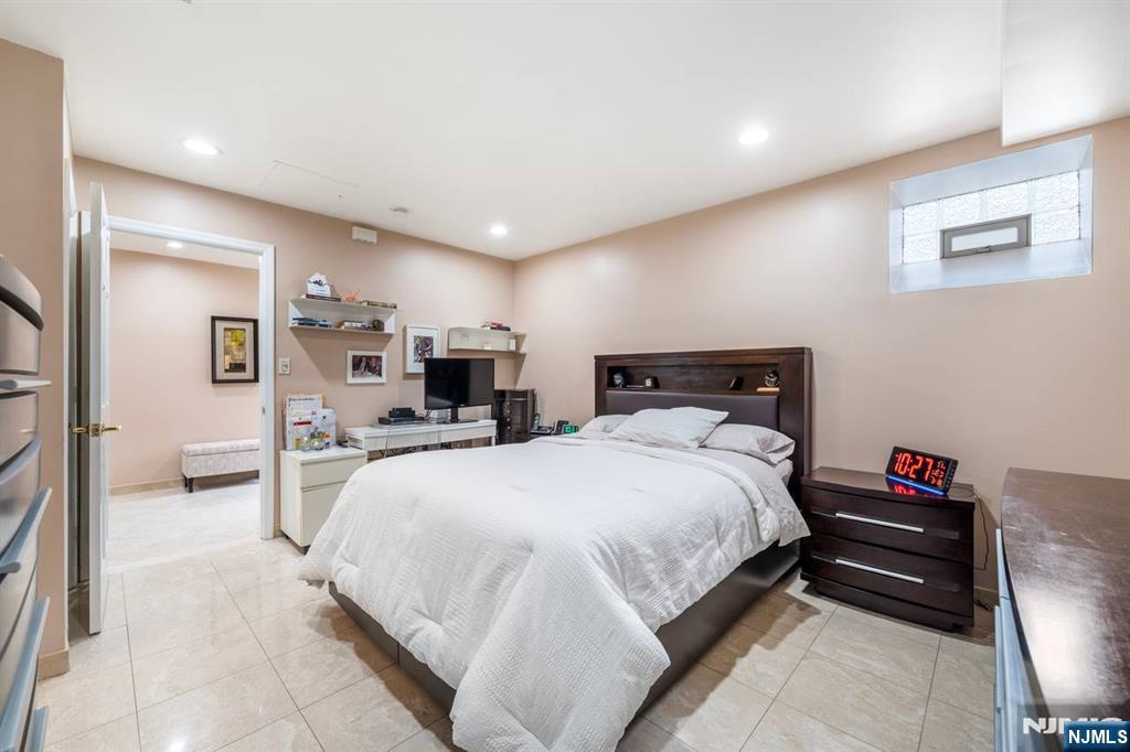 413 Adams Street Hoboken, NJ 07030 - Photo 31 of 40 a bedroom with bed a table and chair