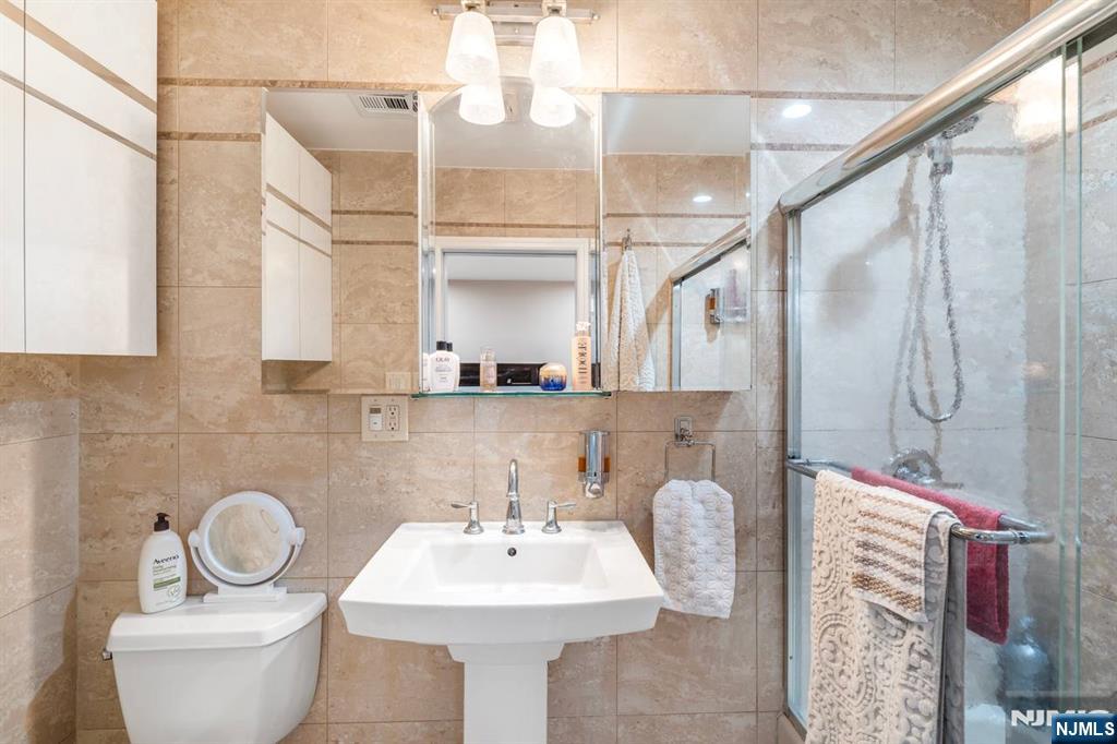 413 Adams Street Hoboken, NJ 07030 - Photo 32 of 40 a bathroom with a sink toilet and shower