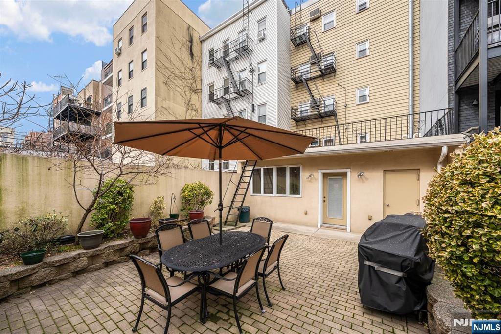 413 Adams Street Hoboken, NJ 07030 - Photo 37 of 40 a view of a chairs and table in the patio