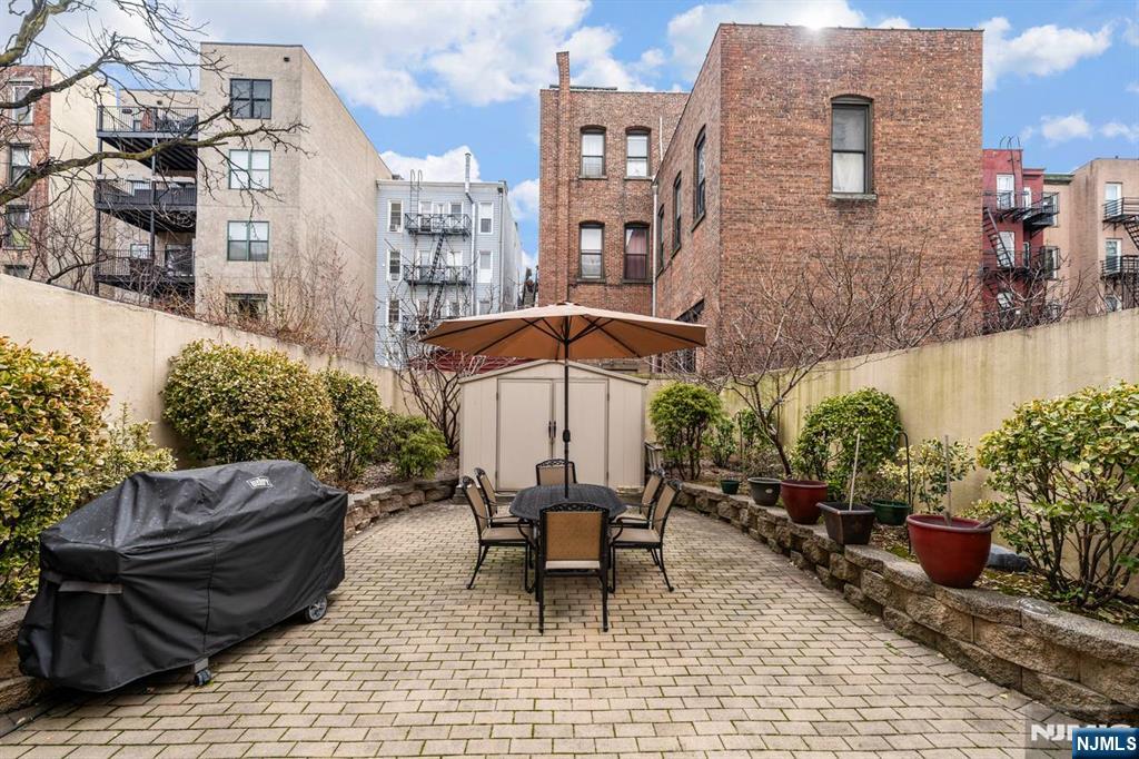 413 Adams Street Hoboken, NJ 07030 - Photo 38 of 40 a view of a patio with couple of chairs and a fountain