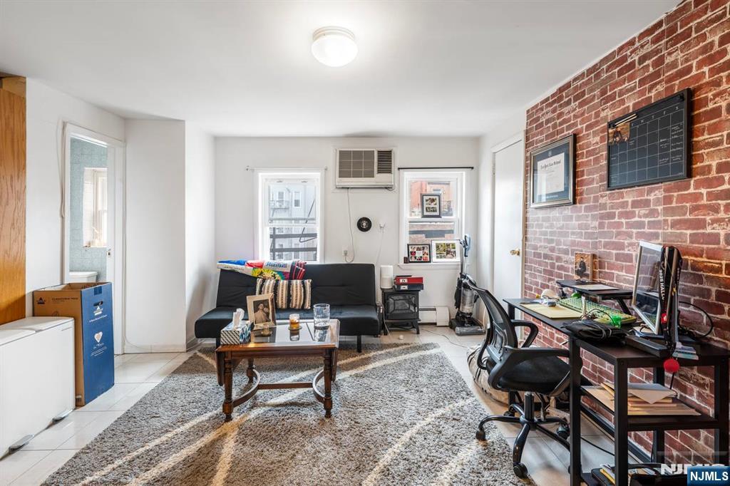 413 Adams Street Hoboken, NJ 07030 - Photo 6 of 40 a living room with furniture a rug and a fireplace