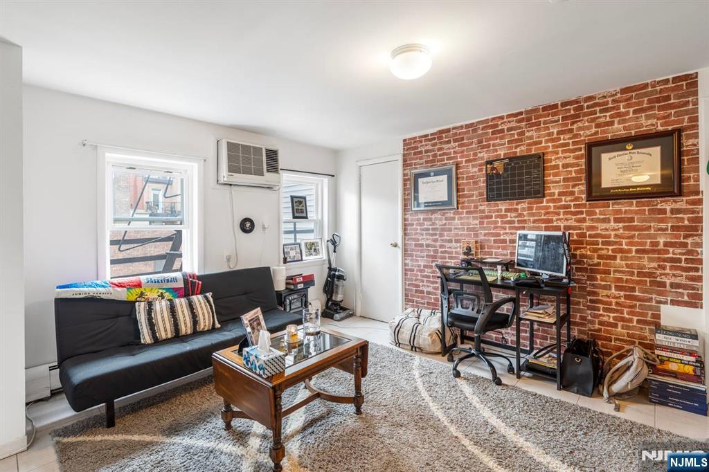 413 Adams Street Hoboken, NJ 07030 - Photo 7 of 40 a living room with furniture and a dining table with rug