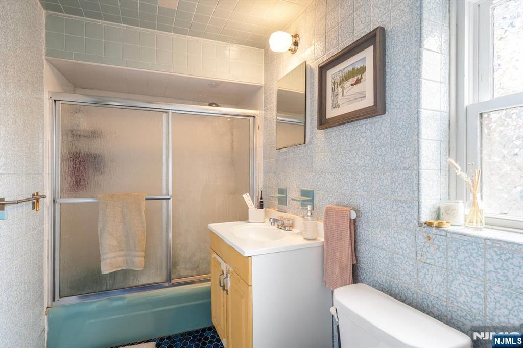 413 Adams Street Hoboken, NJ 07030 - Photo 10 of 40 a bathroom with a sink a toilet and shower