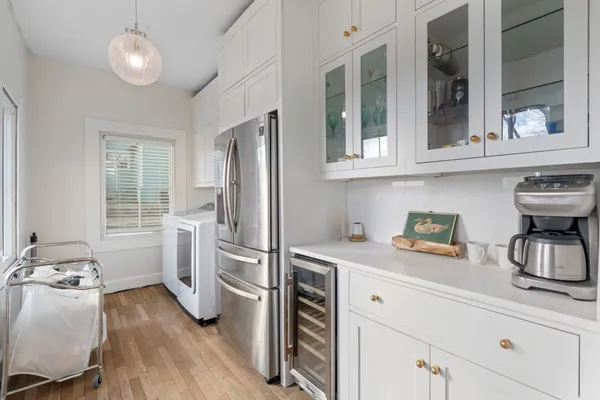 a kitchen with refrigerator and cabinets