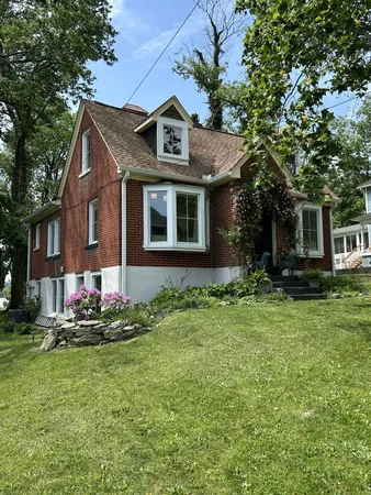 a front view of a house with a garden