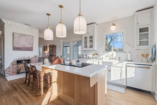 a view of a a dining table chairs and chandelier