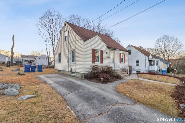 a view of a house with a yard and garage
