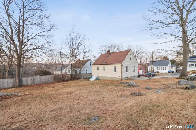 a view of a house with a snow in front of yard