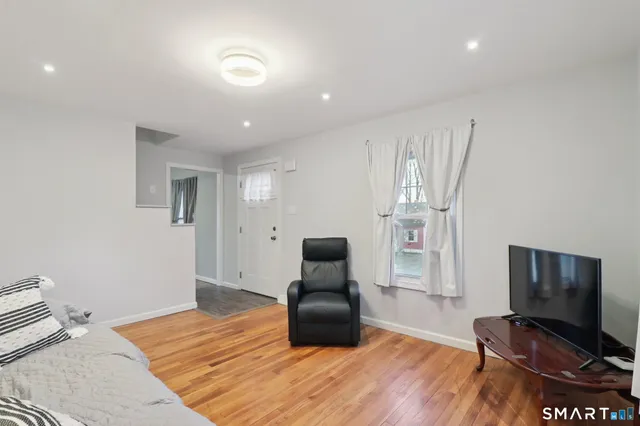 a bedroom with furniture and wooden floor