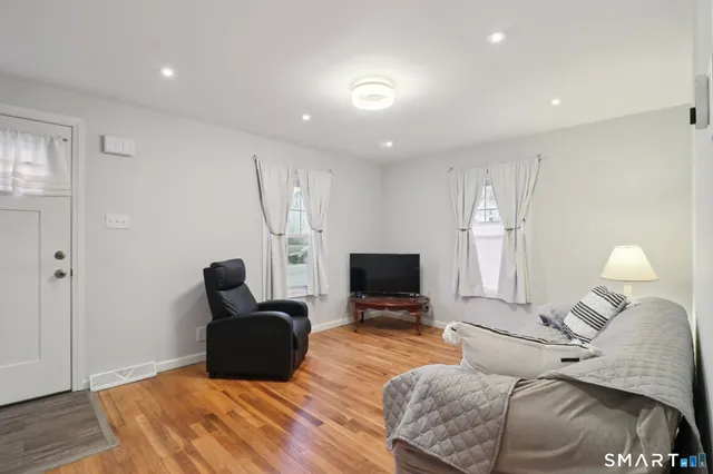 a bedroom with furniture and a flat screen tv