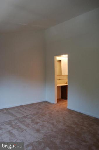 69 Kinsman View Circle Silver Spring, MD 20901 - Photo 8 of 12 a view of an empty room with a fireplace and a window