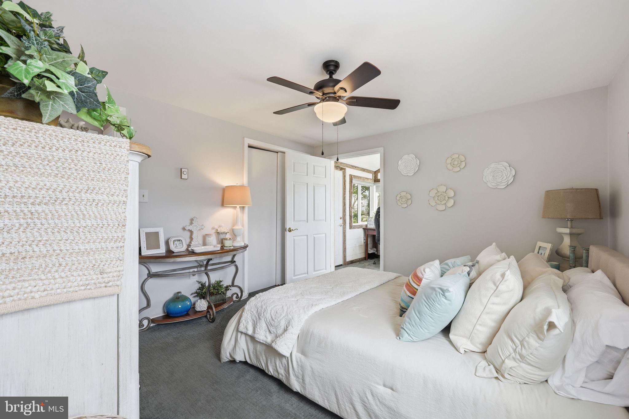 173 Cove Road Newport, NJ 08345 - Photo 24 of 72 a bedroom with a bed and a chandelier