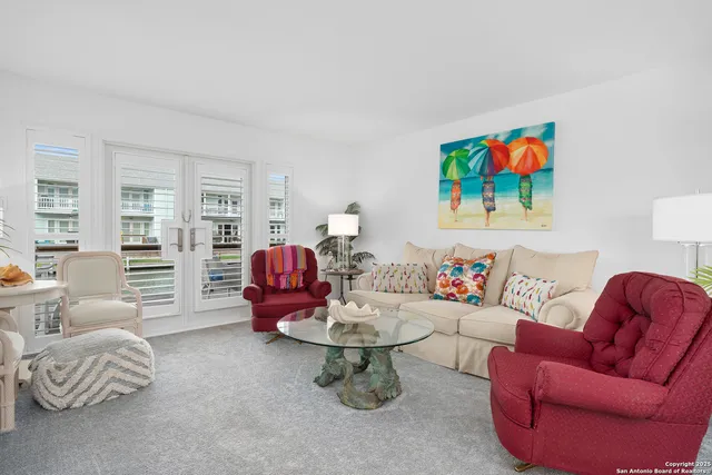a living room with furniture a rug and a window