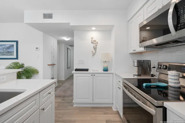 a kitchen with stainless steel appliances granite countertop a sink and cabinets