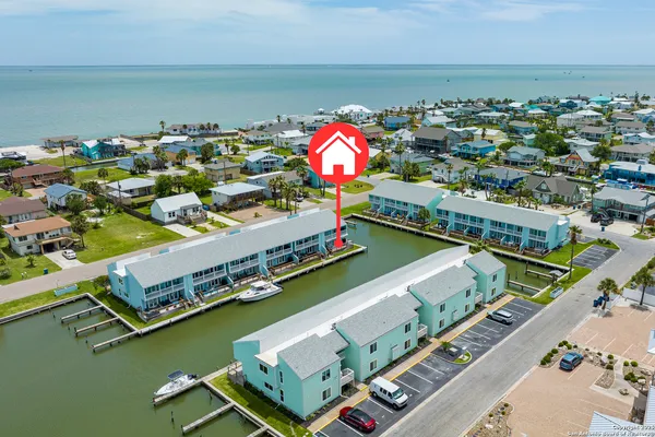 a bathroom with a granite countertop sink a toilet a mirror and shower