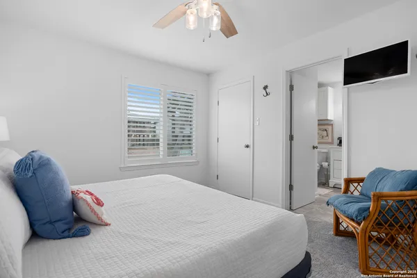 a bedroom with a bed and a chair