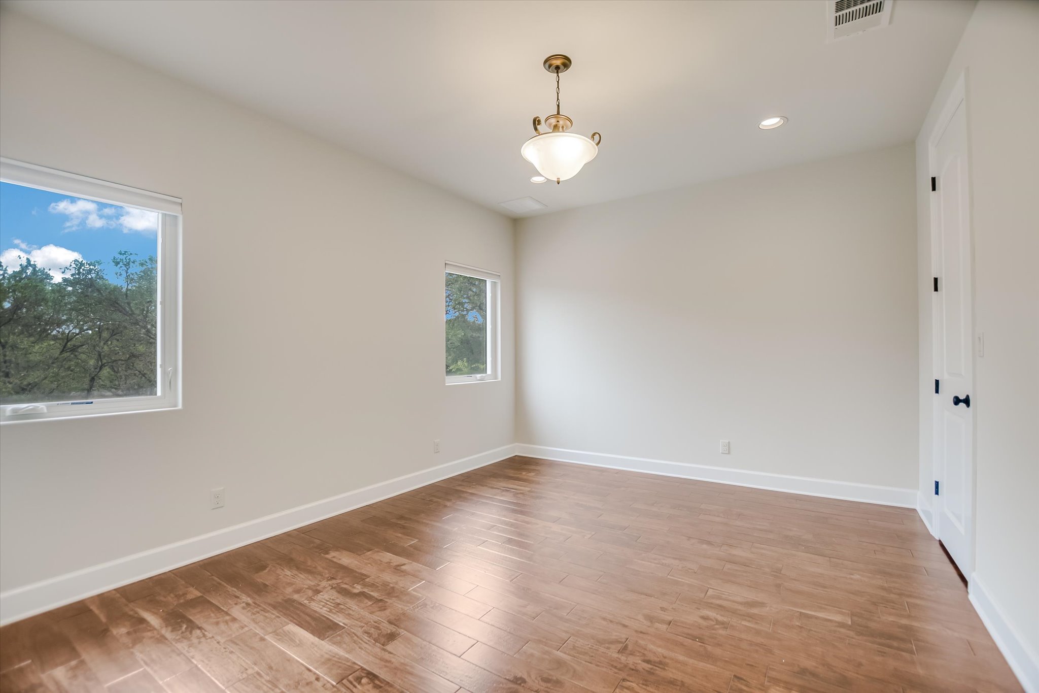 11 Inwood Circle Austin, TX 78746 - Photo 25 of 38 Rich hardwood flooring complements the naturally illuminated interior, ready for personalization.