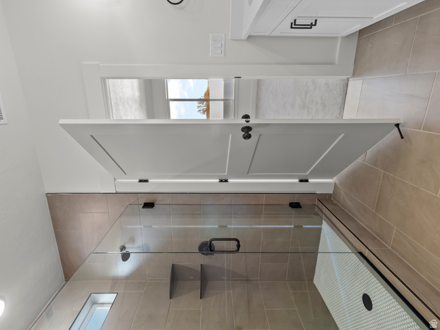 537 South Rivergate Drive Logan, UT 84321 - Photo 12 of 20 Walk-in shower with clear glass enclosure and tile surround