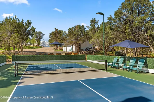 a view of a roof deck with wooden fence and a couple of chairs