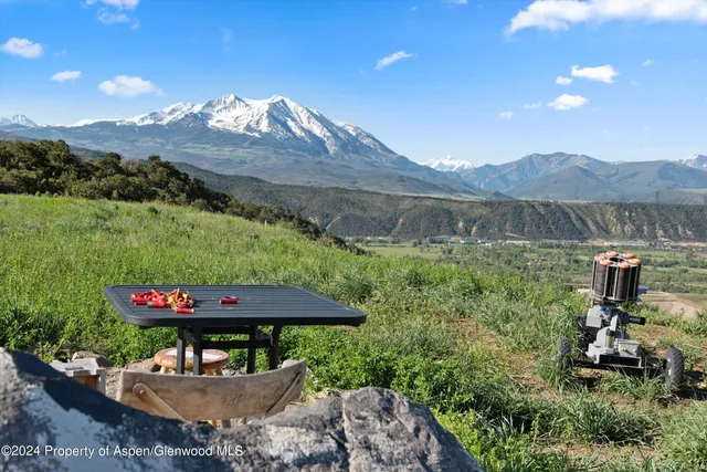 a kitchen with a table chairs stove and wooden floor