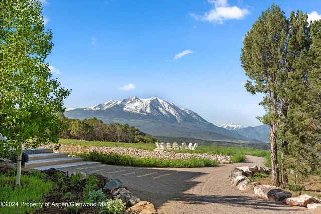 a kitchen with stainless steel appliances granite countertop a sink a microwave cabinets and a dining table
