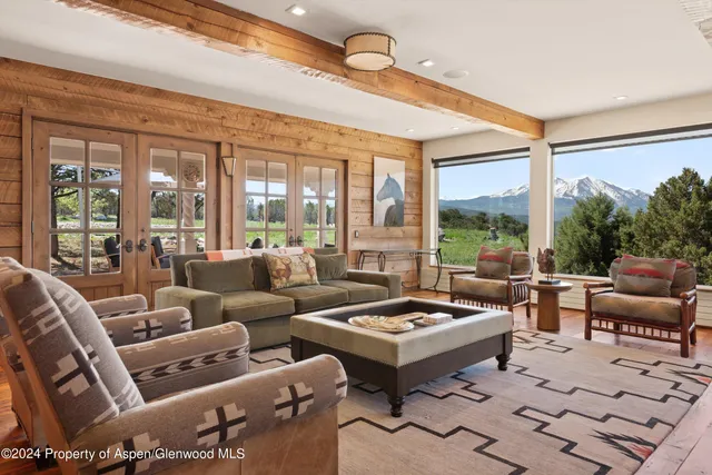 a bed sitting in a bedroom next to a large window