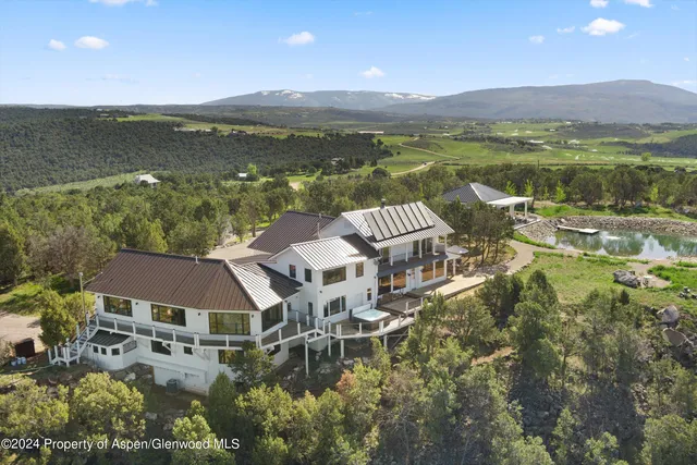 a very nice looking living room with a large window and a flat screen tv