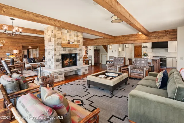 a bedroom with a bed and large windows